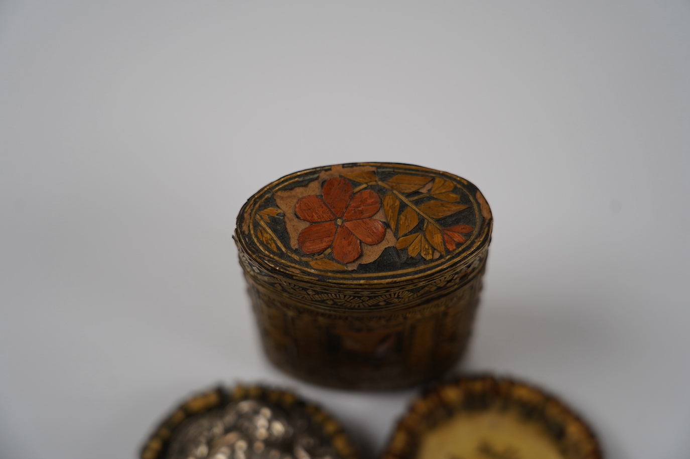 Two 19th century Scottish staghorn snuff boxes. one inscribed 'Mills, THE GIFT of Mr Bedford', with horn lid, 6.5cm, the other with white metal mounts, 6.5cm and a straw-work box, 8.5cm. Condition - staghorn boxes good,